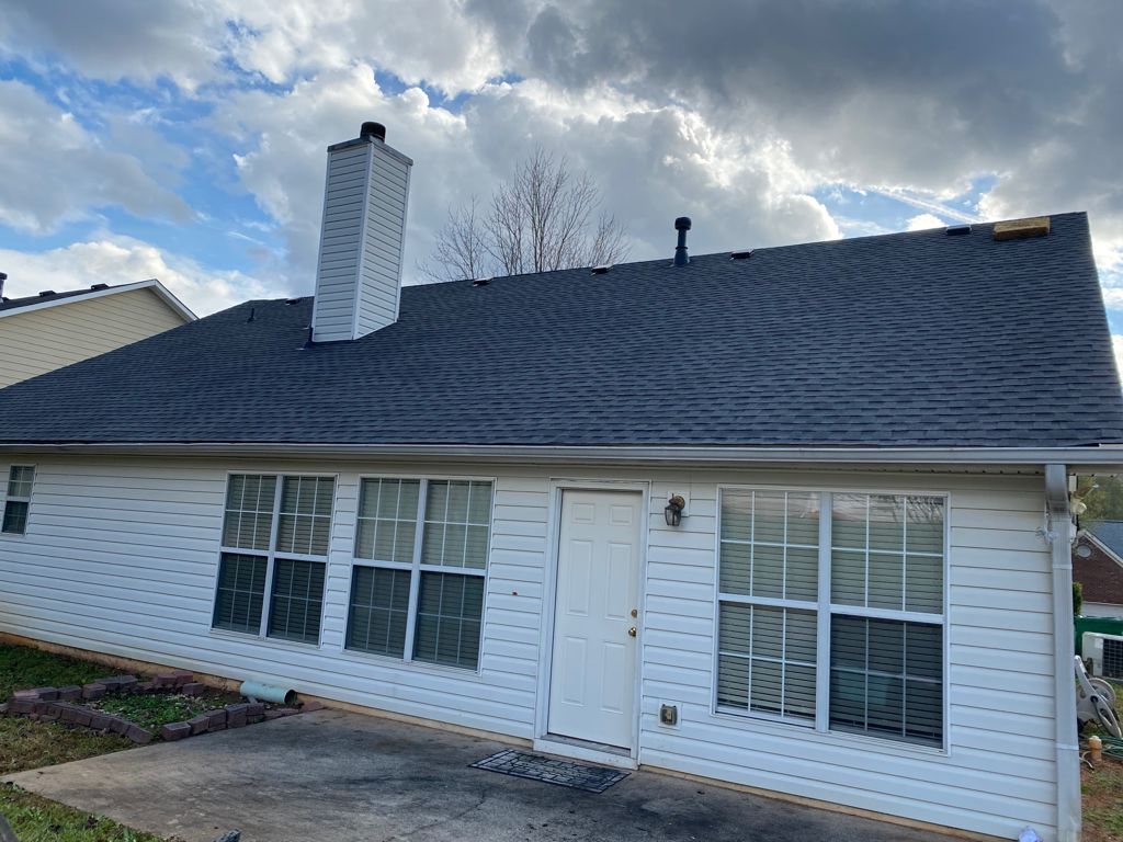 Finished residential roof with chimney